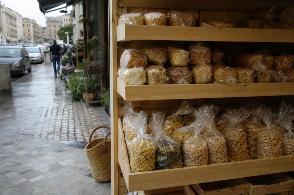 A shelf of packaged gluten-free bread and pasta in an Italian shop