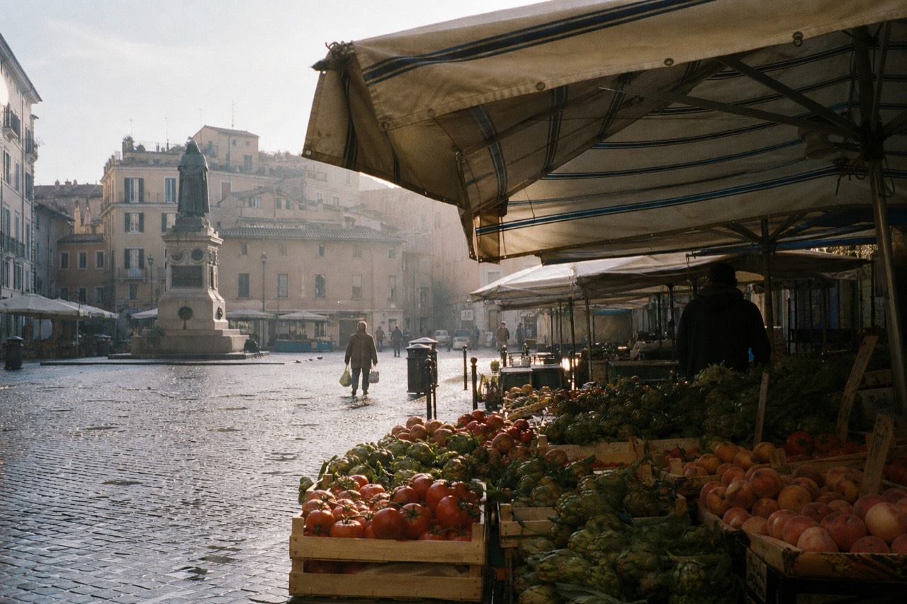 Market stalls piled with fresh vegetables and fruit under awnings in a Roman square